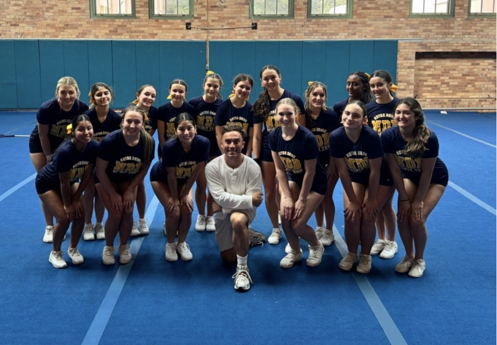 Varsity Cheer Team poses with Choreographer Connor Huber.